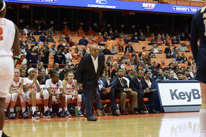 SU head coach Quentin Hillsman and Cedric Solice, directly to Hillsman's right, watch as Syracuse faces Pitt.